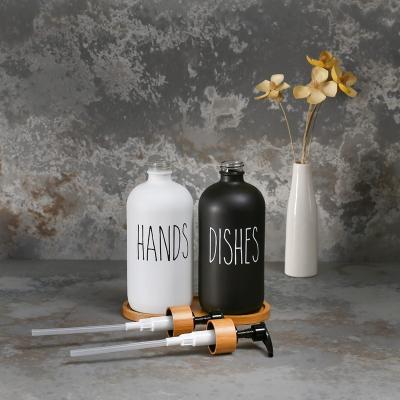 China Personal Care Wholesale 250ml 500ml Boston Round Logo Customization Amber Frosted Black Glass Soap Dispenser With Stainless Steel Pump for sale