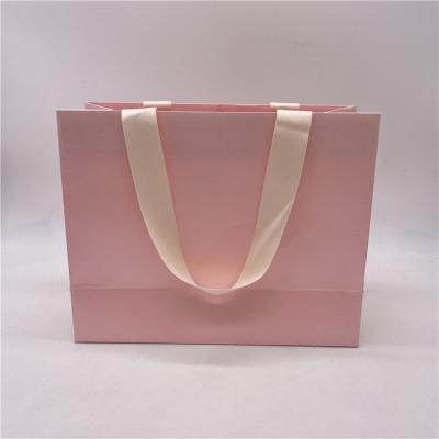 China Recycled Materials Wholesale Luxury Tote Bag Shopping Paper Bags Boutique Custom Waterproof Rose Perfume Packaging Bag for sale