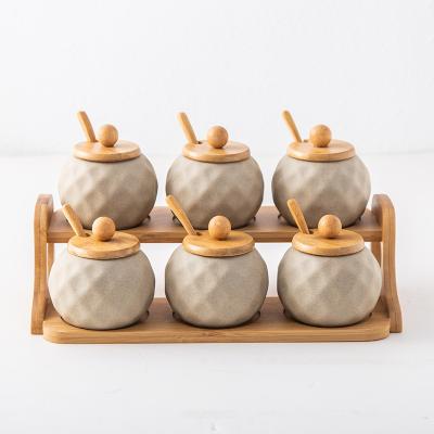 China Sustainable Wholesale Luxury Ceramic Condiment Porcelain Pottery Seasoning Container Set Spice Jars With Bamboo Wood Lid for sale