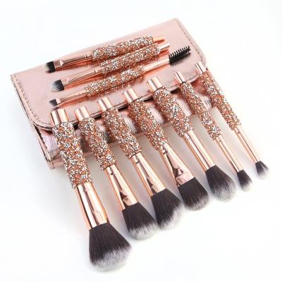 China Angular Blush Diamond Glitter Handle Base Rose Makeup Brushes 10pcs Rhinestone Gold Crystal Makeup Brush With PU Bag for sale