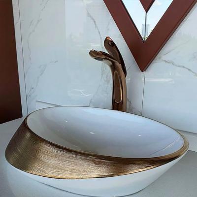 China Small Apartment Household Sink Light Luxury Classic Art Oval Designs Mounted Gold Brushed Above Counter Ceramic Hand Wash Basin for sale