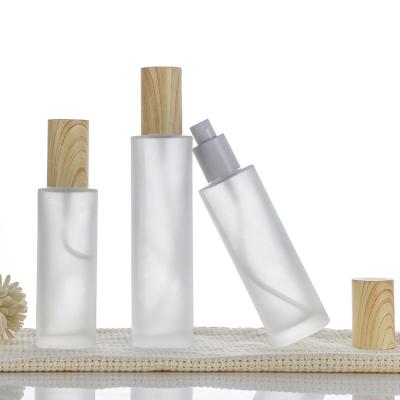 China Lotion Pump Glass Cosmetic Packaging Bottle With Bamboo Cap Glass Bamboo Lotion Pump Bottle for sale