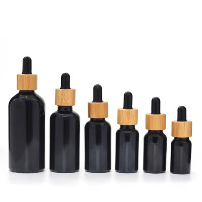 China 5ml 10ml 15ml 20ml 30ml 50ml 100ml Cosmetic Matte/Essential Oil Shiny Black Serum Dropper Glass Bottle With Bamboo Cap for sale