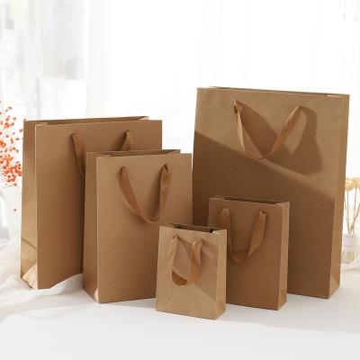 China Biodegradable Vertical Advertising Deli Packaged Gift Clothing Store Milk Tea Shop Printed Logo Bag Drawstring Custom Large Kraft Paper for sale