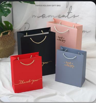 China Recyclable Gold Paper Gift Hot Stamping Bags For Clothes Packaging Bag Gift Boxes for sale