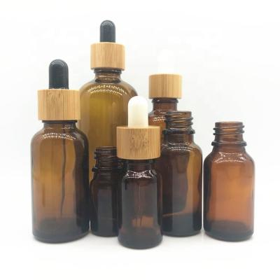 China Personal Care Essential Oil Dropper Lid Glass Bamboo Bottles With Wooden Dropper Cap For Cosmetic Packaging for sale