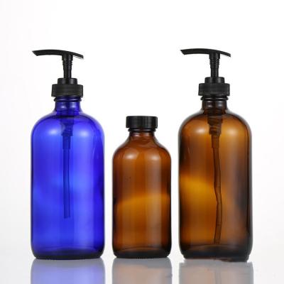 China 500ml Boston Cosmetic Glass Round Glass Bottle With Black Pump Lid For Liquid Soap Foam for sale