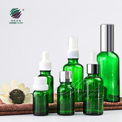 China Personal Care Packaging 5ml 10ml 15ml 20ml 30ml 50ml 100ml Cosmetic Green Glass Essential Oil Serum Dropper Bottle With Tamper Proof Child Cap for sale