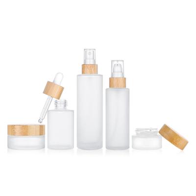 China Cosmetic High End Frosted Bamboo Cosmetic Matte Glass Bottle And Jar Pump Bottle For Lotion Serum Cream Full Set for sale