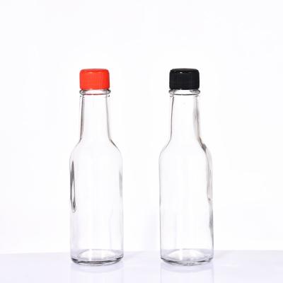 China Wholesale Price Food Bottles With Caps 100ml 150ml 250ml Clear Round Sauce Dazed Glass Bottle for sale