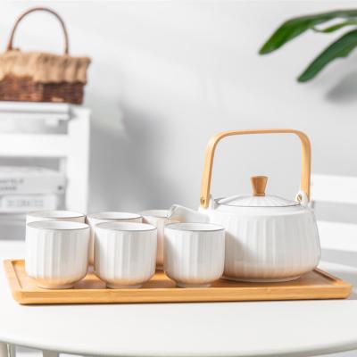 China Wholesale 8PCS Viable Home Tea Party Afternoon White Embossed Tea Cup Sets Porcelain Ceramic Tea Set With Wooden Teapot Tray for sale