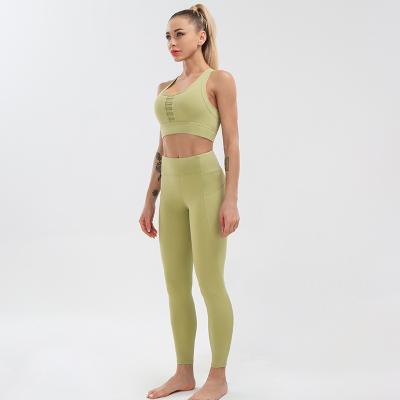 China Breathable women leggings pocket yoga set runner back gym bra fitness set splicing hollow yoga bra and suit high waist sports leggings for sale