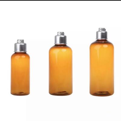 China 100ml 200ml 300ml Cosmetic Packaging Container Clear Brown Pet Bottle With Sliver Fold Lid for sale