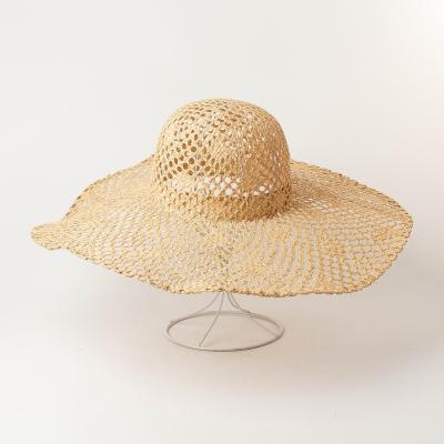 China Handwoven Hollow-out Picture Fashion Straw Hat With Big Eaves Girls Beach Straw Hat for sale