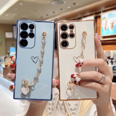 China Fashion INS Heart Shockproof Wristband Plating Soft TPU Wristband Mobile Phone Case For Samsung Galaxy S22 Plus S21 Ultra S21FE for sale