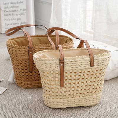 China 2022 New Fashion Portable Simple White Khaki Women's Straw Tote Bag Hollow Large Capacity for sale