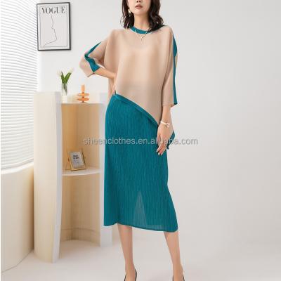 China Anti-pilling Miyake Pleated 2022 Autumn New Fashion Color Matching Women's Round Neck Slit Top Skirt Two-piece Set Suit Women for sale