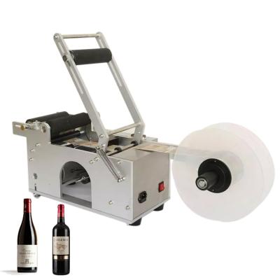 China PLC semi-automatic control food manual labeling machine round wine bottle adhesive sticker with handle labeling machine for sale