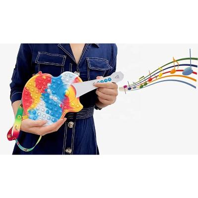 China Sustainable Educational Toys Music Guitar Kids Silicon Cross - Body Sling Guitar Buster Push Noise Bag Large For Anxiety Relief for sale