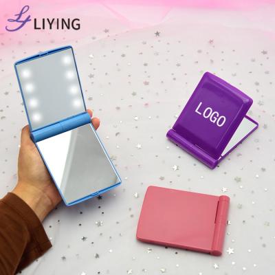 China Mini Handheld LED Lighted Makeup Mirror Small Foldable Handheld Travel Pocket Cosmetic Portable Lighted Mirror Gift Beauty Hand Mirror for sale