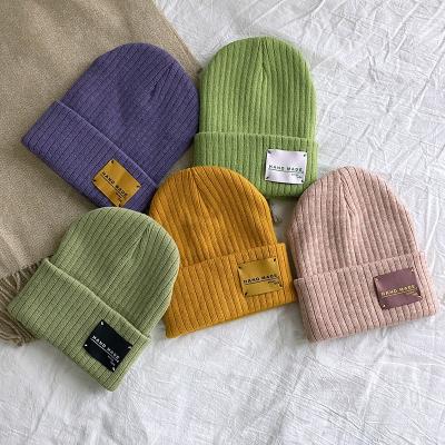 China COMMON Acrylic Winter Knit Hat Beanie With Sibutu Leather Patch Caps On Sale for sale