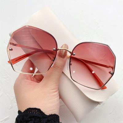 China Translucent summer 2022 sunglasses 2022 ocean edge polygon piece 2022 new polygonal cut rimless sunglasses women for sale