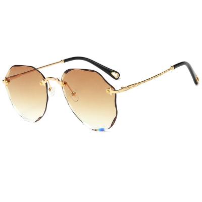 China Rimless trend of new polygon sunglasses women 2022 cut edge gradient fashion sunglasses women metal polygonal sunglasses 2022 for sale