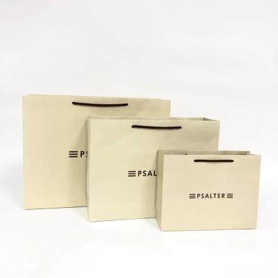 China Recycled Materials Luxury Prime Branded Packing Custom Logo Print Wholesale Ivory Cardboard Paper Bag with Cotton Rope Handles for sale