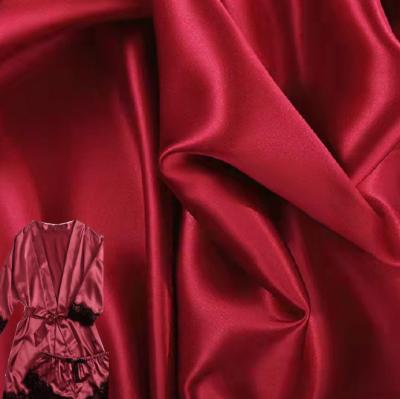 China Stain Repellent Colorful Luminous Soft Satin Polyester Fabrics Most Popular Reliable Fabric Quality For Sexy Nightgowns for sale