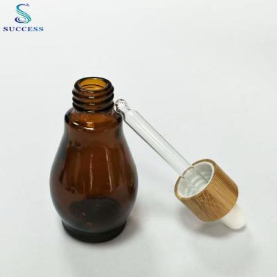 China Personal Care Control Cap Bamboo Dropper Empty 30ml Tear Shaped Glass Bottle Essential Oil Bottle for sale