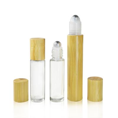 China 10ml 15ml Multifunctional Glass Metal Roll On Perfume Clear Roll On Glass Bottle With Bamboo Lid for sale