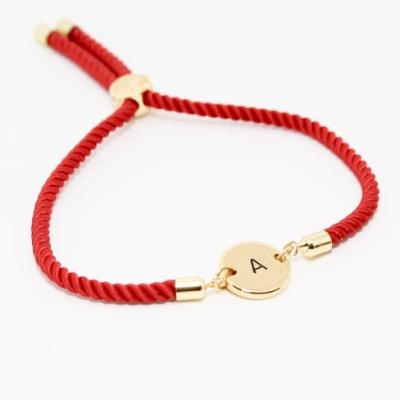 China TRENDY Personalized Stainless Steel Jewelry Gold Slider Disc Engraved Initial Letter Nylon Rope Bracelet With Letter Adjustable Women for sale