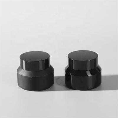 China 30ml Cream Cosmetic Packaging Jars Matt Black Glass Round Jars Cosmetic Cream Jar Glass With Black Cap for sale