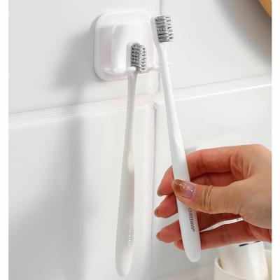 China Behind Doors/On Walls Creative Toothbrush Holder Self-adhesive Bathroom Toilet Shaver Storage Holder Punch-free Tooth Cup Holder For Bathroom for sale