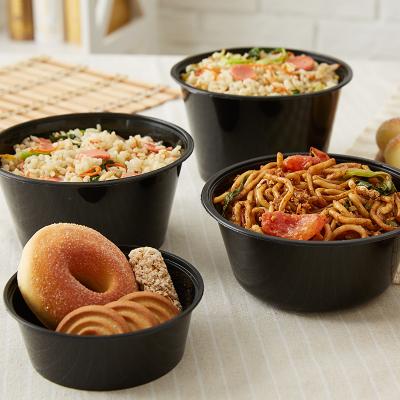 China Food grade pp round shape stocked black plastic food container for take away not easy to leak with lid for sale