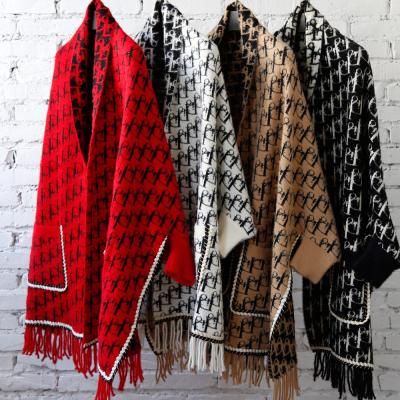 China Women super soft good quality winter warm anti-pilling cape knitted shawls shrug with tassel for sale