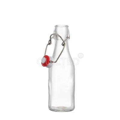 China Beverage Stored Round 250ml 500ml 1000ml Drinking Water Clear Juice Kombucha Swing Top Glass Bottle Food Grade for sale