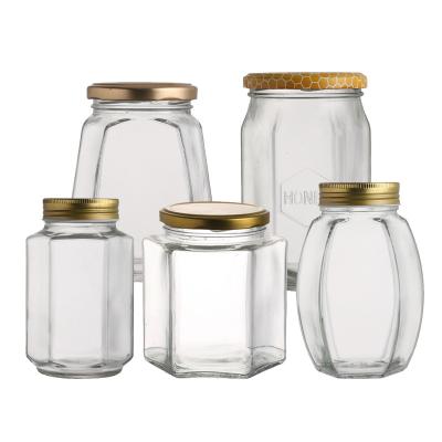 China Honey Canning Cookie Jam Food All Kinds Of Hex Jar 500g 380ml Glass Airtight Oval Hexagonal Honey Glass Jar With Metal Lip for sale