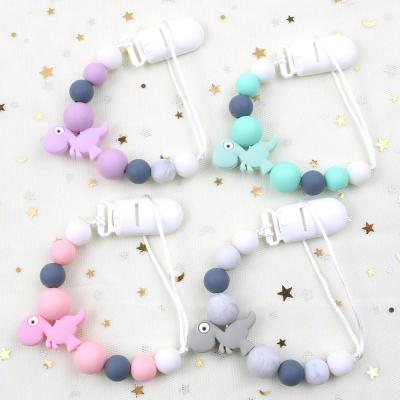 China BPA Free Wholesale Dummy Silicone Soother Pacifier Clip Dinosaur Pacifier Chain Holder Baby Shower Gift For for sale