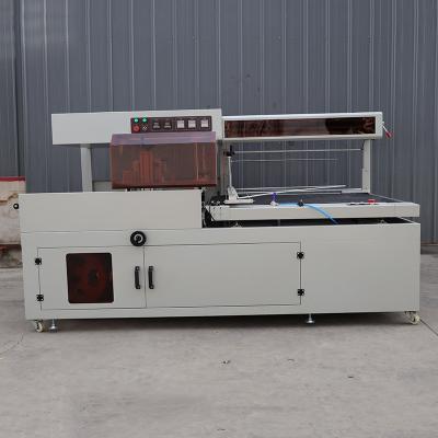 China Pneumatische thermoscrinkbare plastic filmverpakkingsmachine voor voedingsmiddelen en dranken Te koop