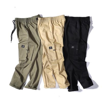 China QUICK DRY Boutique Multi Pocket Cargo Pants High Street Fashion Loose Long Pants For Men for sale