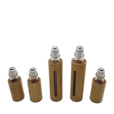 China Cosmetic all plastic bamboo essential oil roller bottle and perfume wooden packaging essential oil shell trunnion ball bottle for sale