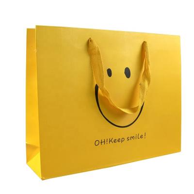 China Recycled Materials Boutique Art Paper Bag Luxury Decorative Paper With Logo Yellow For Shopping Paper Bag for sale