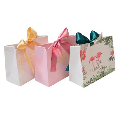 China New Recycled Materials Design Paper Bag Wedding Candy Sugar Gift Packaging Custom Shopping Bags With Ribbon for sale