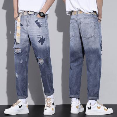 China Breathable 2022 Style Men Ripped Letter Printed Straight Wide Leg Jeans Pants for sale