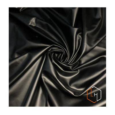 China Surface Waterproof Shiny Black Elastic Imitation Stretch Matte PU Face Stain Fabric For Jacket Suit for sale