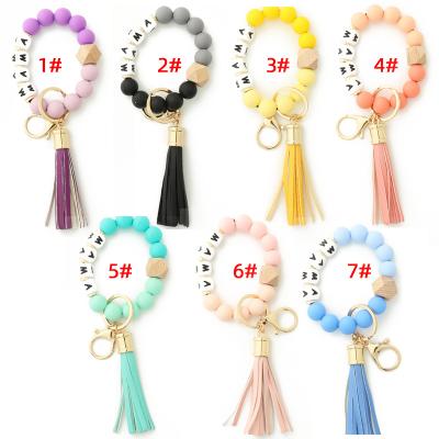 China Tassels Beaded Leather Car Key Chain Bracelet Promotion DIY Gift Letters Silicone Wristband Keychain Key Ring For Women for sale