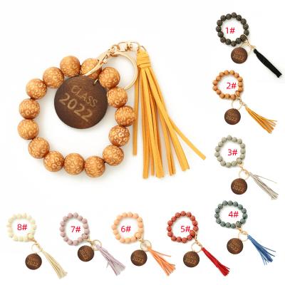 China Promotion Bracelet Key Chain Gift Personalized Wood Beaded Bracelet Key Chain With DISC Monogram DIY Wooden Bead Tassel Gift Keychains for sale