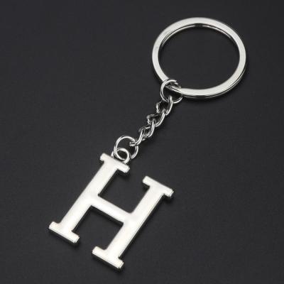 China Gens Art Custom 26 Silver Plated White Zinc Alloy Laser Logo Key Chain Engraved Name Letters Metal Key Chain for sale