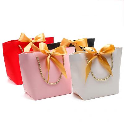 China Customized Best Selling Black Luxury Recyclable Logo Luxury Golden Ribbon Paper Jewelry Paper Bags for sale